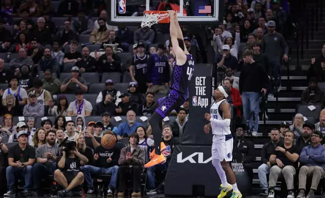 Sacramento Kings center Maxime Raynaud (42) dunks the ball during the first half of an NBA basketball game against the Dallas Mavericks, Tuesday, Jan. 6, 2026, in Sacramento, Calif. (AP Photo/Scott Marshall)