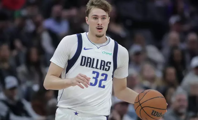 Dallas Mavericks forward Cooper Flagg dribbles the ball up court during the first half of an NBA basketball game against the Sacramento Kings, Tuesday, Jan. 6, 2026, in Sacramento, Calif. (AP Photo/Scott Marshall)