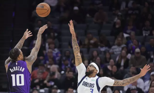 Sacramento Kings guard Demar Derozan (10) shoots a 3-point shot over Dallas Mavericks forward Anthony Davis (3) during the first half of an NBA basketball game Tuesday, Jan. 6, 2026, in Sacramento, Calif. (AP Photo/Scott Marshall)