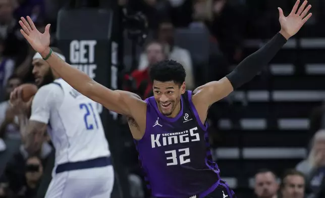 Sacramento Kings center Dylan Cardwell (32) reacts after dunking the ball against the Dallas Mavericks during the first half of an NBA basketball game Tuesday, Jan. 6, 2026, in Sacramento, Calif. (AP Photo/Scott Marshall)
