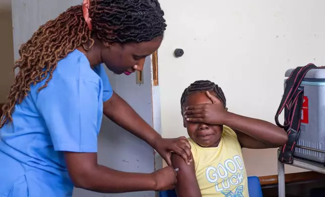 A 10-year-old girl reacts after receiving a free dose of the HPV vaccine at Budiriro Polyclinic in Harare, Zimbabwe, Saturday, Jan. 17, 2026. (AP Photo/Aaron Ufumeli)