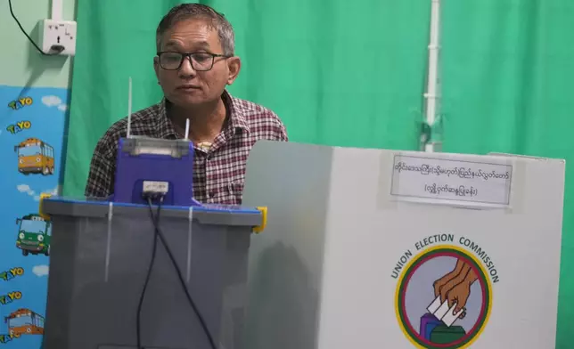 A voter casts ballot at a polling station during the second phase of general election Sunday, Jan. 11, 2026, in Yangon, Myanmar. (AP Photo/Thein Zaw)