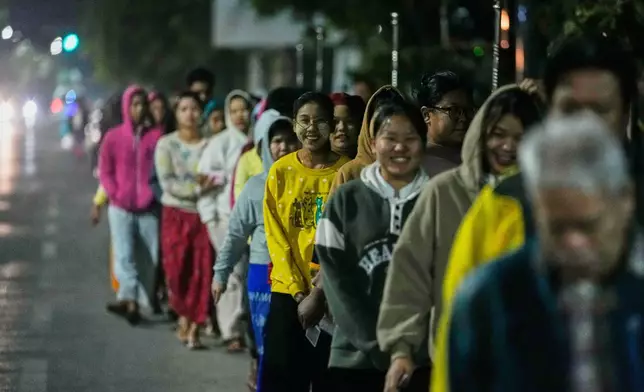 Voters wait for a polling station to open during the second phase of general election in Mandalay, central Myanmar, Sunday, Jan. 11, 2026. (AP Photo/Aung Shine Oo)