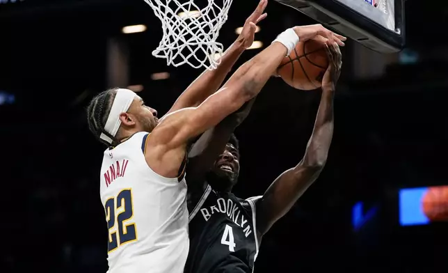 Denver Nuggets forward Zeke Nnaji (22) blocks Brooklyn Nets guard Drake Powell (4) during the first half of an NBA basketball game, Sunday, Jan. 4, 2026, in New York. (AP Photo/Yuki Iwamura)
