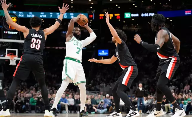 Boston Celtics guard Jaylen Brown (7) is double-teamed by Portland Trail Blazers forward Toumani Camara (33) and guard Shaedon Sharpe, second from right, during the first half of an NBA basketball game Monday, Jan. 26, 2026, in Boston. (AP Photo/Robert F. Bukaty)