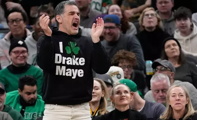 Boston Celtics owner Bill Chisholm, front left, cheers during the second half of an NBA basketball game against the Portland Trail Blazers, Monday, Jan. 26, 2026, in Boston. (AP Photo/Robert F. Bukaty)