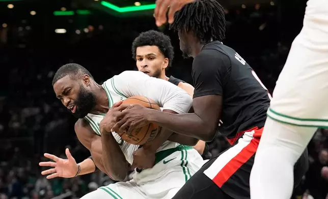 Boston Celtics guard Jaylen Brown (7) fights for possession with Portland Trail Blazers guard Sidy Cissoko (91) during the first half of an NBA basketball game Monday, Jan. 26, 2026, in Boston. (AP Photo/Robert F. Bukaty)
