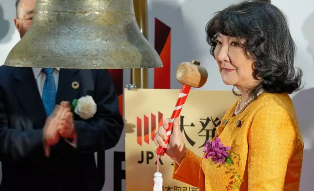 Finance Minister Satsuki Katayama rings the bell during a ceremony marking the start of trading at the Tokyo Stock Exchange, Monday, Jan. 5, 2026, in Tokyo. (AP Photo/Eugene Hoshiko)