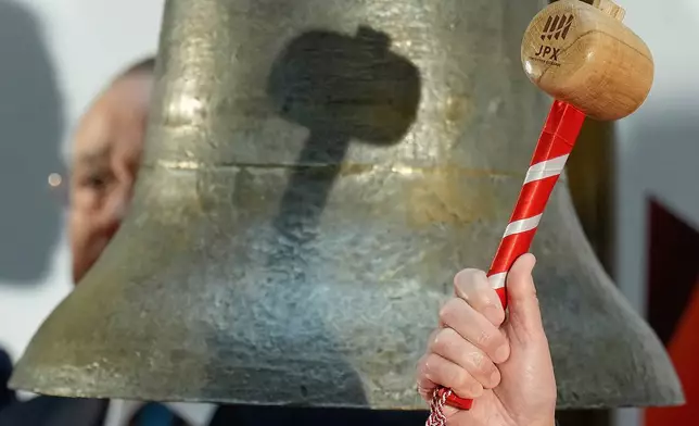 Yoshinobu Tsutsui, the head of Keidanren, Japan's major business federation, holds a wooden mallet to ring the bell during a ceremony marking the start of trading at the Tokyo Stock Exchange, Monday, Jan. 5, 2026, in Tokyo. (AP Photo/Eugene Hoshiko)