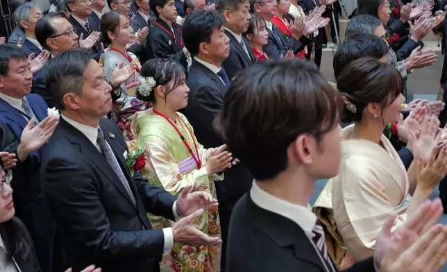 Staff of the Tokyo Stock Exchange and guests make a ceremonial hand-clapping during a ceremony marking the start of trading at the Tokyo Stock Exchange, Monday, Jan. 5, 2026, in Tokyo. (AP Photo/Eugene Hoshiko)