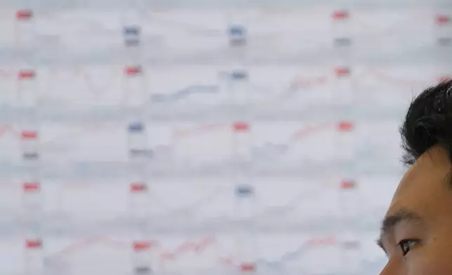 A dealer watches computer monitors at a dealing room of Hana Bank in Seoul, South Korea, Monday, Jan. 5, 2026. (AP Photo/Lee Jin-man)