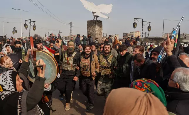 Kurdish fighters with the Syrian Democratic Forces (SDF) are cheered by local residents ahead of the end of a four-day truce with the Syrian government in Hassakeh, northeastern Syria, Saturday, Jan. 24, 2026. (AP Photo/Baderkhan Ahmad)