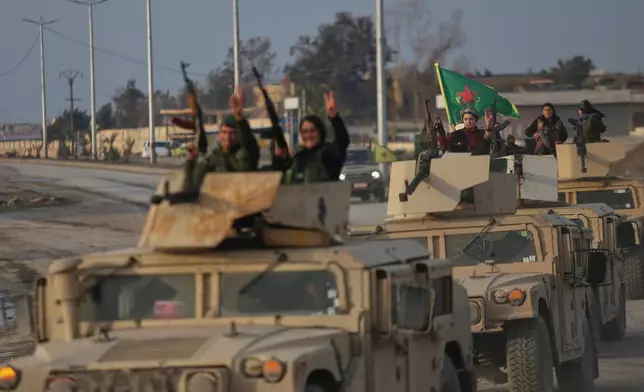 A convoy of Kurdish fighters with the Syrian Democratic Forces (SDF) flashes victory signs as it heads toward the front line ahead of the end of a four-day truce with the Syrian government in Hassakeh, northeastern Syria, Saturday, Jan. 24, 2026. (AP Photo/Baderkhan Ahmad)