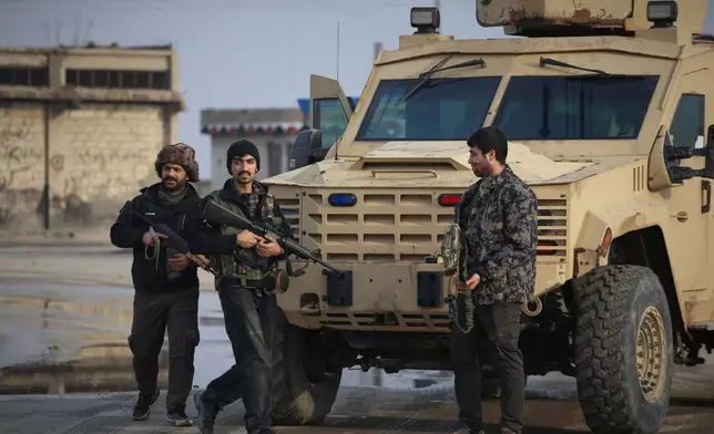 Kurdish fighters with the Syrian Democratic Forces (SDF) prepare to head toward the front line ahead of the end of a four-day truce with the Syrian government in Hassakeh, northeastern Syria, Saturday, Jan. 24, 2026. (AP Photo/Baderkhan Ahmad)