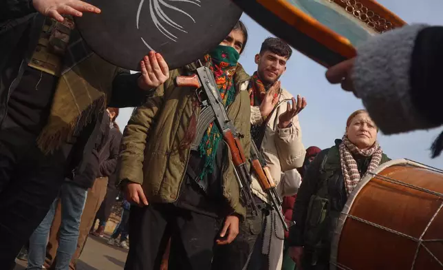 Kurdish fighters with the Syrian Democratic Forces (SDF) are cheered by local residents ahead of the end of a four-day truce with the Syrian government in Hassakeh, northeastern Syria, Saturday, Jan. 24, 2026. (AP Photo/Baderkhan Ahmad)
