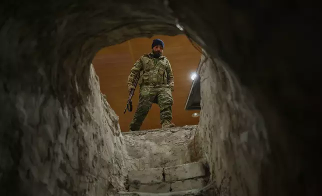 A Syrian security force member stands at the entrance of a tunnel used by retreating Syrian Democratic Forces (SDF) fighters inside the military hospital compound in the town of Ain Issa, northeastern Syria, Saturday, Jan. 24, 2026. (AP Photo/Ghaith Alsayed)