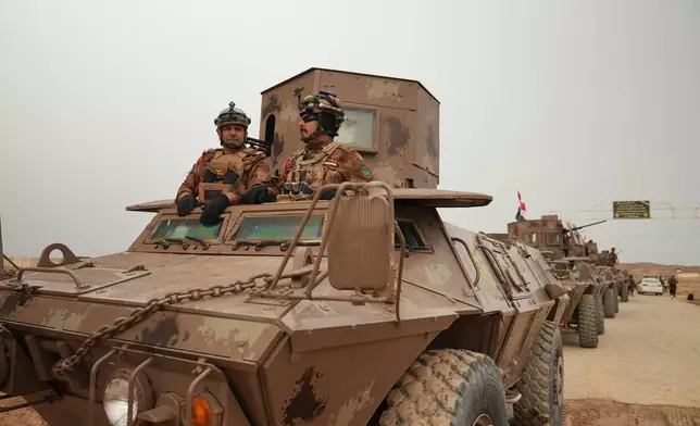 Iraqi Border Guards patrol in armored vehicles along the border with Syria, in Sinjar, northern Iraq, Thursday, Jan. 22, 2026. (AP Photo/Farid Abdulwahed)