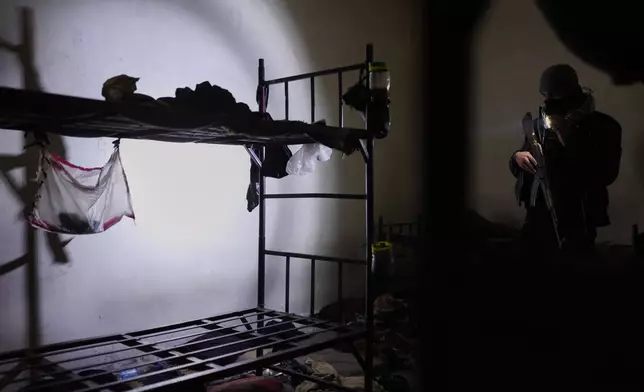 A soldier observes a prison room after Syrian government forces took over the town from the U.S.-backed Syrian Democratic Forces (SDF), in Tabqa, eastern Syria, Sunday, Jan. 18, 2026. (AP Photo/Ghaith Alsayed)