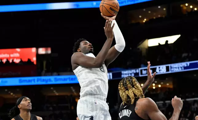 Memphis Grizzlies forward Jaren Jackson Jr. shoots over Brooklyn Nets forward Noah Clowney in the first half of an NBA basketball game, Sunday, Jan. 11, 2026, in Memphis, Tenn. (AP Photo/Brandon Dill)
