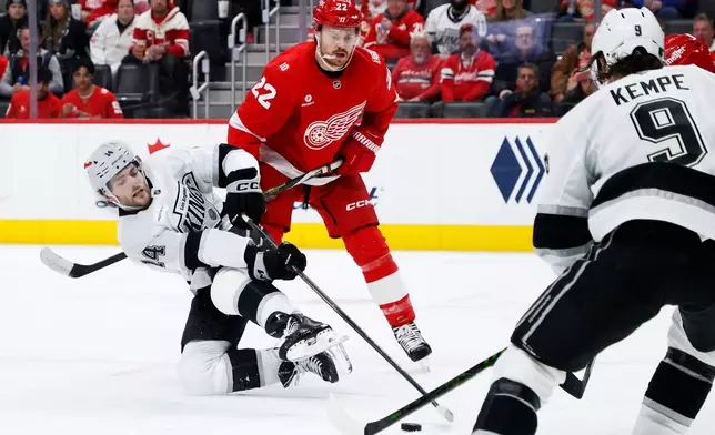 Los Angeles Kings right wing Alex Laferriere (14) tries to get a shot off against Detroit Red Wings center Mason Appleton (22) during the second period of an NHL hockey game Tuesday, Jan. 27, 2026, in Detroit. (AP Photo/Duane Burleson)