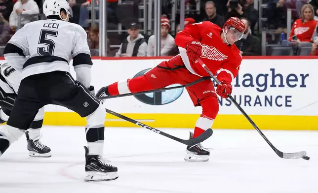 Detroit Red Wings center Andrew Copp takes a shot on goal against Los Angeles Kings defenseman Cody Ceci (5) during the first period of an NHL hockey game, Tuesday, Jan. 27, 2026, in Detroit. (AP Photo/Duane Burleson)