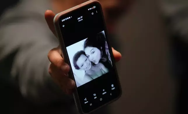 Cheyenne Hangaman shows a photograph of her and her son, Howard, 6, who along with his two brothers Kaleb, 8, and EJ, 9, drowned in a frozen pond Tuesday, Jan. 27, 2026, in Bonham, Texas. (AP Photo/Julio Cortez)