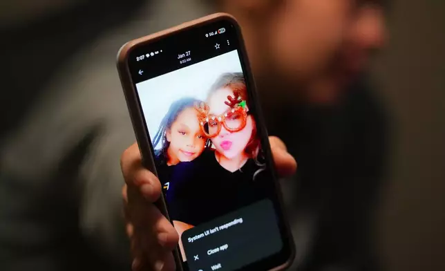 Cheyenne Hangaman shows a photograph of her and her son, Kaleb, 8, who along with his two brothers Howard, 6, and EJ, 9, drowned in a frozen pond Tuesday, Jan. 27, 2026, in Bonham, Texas. (AP Photo/Julio Cortez)
