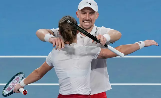 Katarzyna Kawa, left, and Jan Zielinski of Poland celebrate defeating Christian Harrison and Coco Gauff of the U.S. in their semifinal doubles match at the United Cup tennis tournament in Sydney, Saturday, Jan. 10, 2026. (AP Photo/Rick Rycroft)