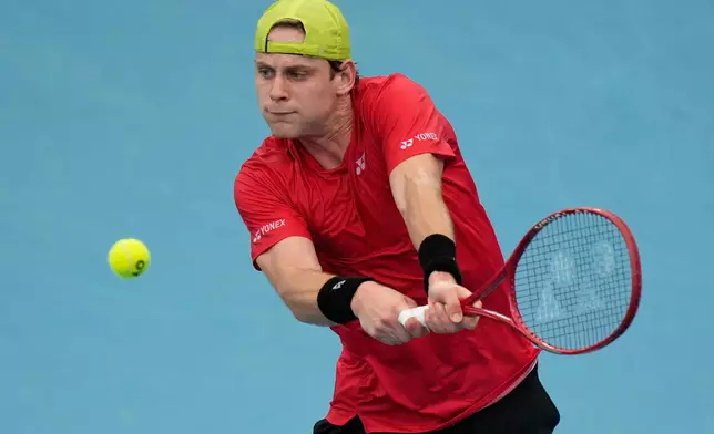Zizou Bergs of Belgium hits a backhand to Stan Wawrinka of Switzerland during their semifinal match at the United Cup tennis tournament in Sydney, Saturday, Jan. 10, 2026. (AP Photo/Rick Rycroft)