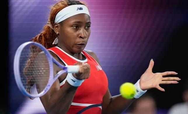 Coco Gauff of the U.S. hits a forehand to Iga Swiatek of Poland during their semifinal match at the United Cup tennis tournament in Sydney, Saturday, Jan. 10, 2026. (AP Photo/Rick Rycroft)