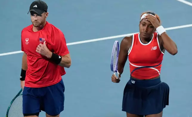 Christian Harrison, left, and Coco Gauff of the U.S. compete against Katarzyna Kawa and Jan Zielinski of Poland during their semifinal doubles match at the United Cup tennis tournament in Sydney, Saturday, Jan. 10, 2026. (AP Photo/Rick Rycroft)