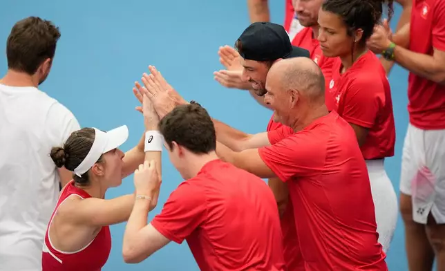 Belinda Bencic of Switzerland, second left, celebrates with teammates after her win over Alise Mertens of Belgium in their semifinal match at the United Cup tennis tournament in Sydney, Saturday, Jan. 10, 2026. (AP Photo/Rick Rycroft)