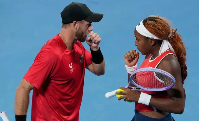 Christian Harrison, left, and Coco Gauff of the U.S. discuss tactics against Katarzyna Kawa and Jan Zielinski of Poland during their semifinal doubles match at the United Cup tennis tournament in Sydney, Saturday, Jan. 10, 2026. (AP Photo/Rick Rycroft)