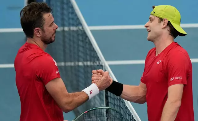Zizou Bergs of Belgium, right, Stan Wawrinka of Switzerland shake hands after Bergs won their semifinal match at the United Cup tennis tournament in Sydney, Saturday, Jan. 10, 2026. (AP Photo/Rick Rycroft)