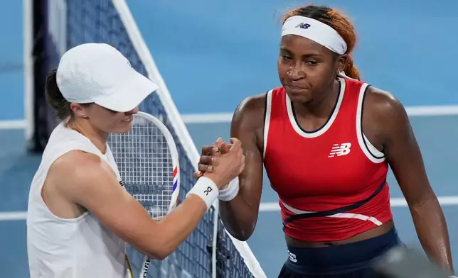 Coco Gauff of the U.S. right, and Iga Swiatek of Poland shake hands after Gauff won their semifinal match at the United Cup tennis tournament in Sydney, Saturday, Jan. 10, 2026. (AP Photo/Rick Rycroft)