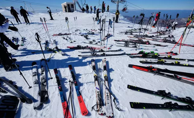 Skis and poles are left on the snow as skiers take a break at the Mzaar-Kfardebian ski resort northeast of Beirut, Lebanon, Saturday, Jan. 3, 2026. (AP Photo/Hassan Ammar)