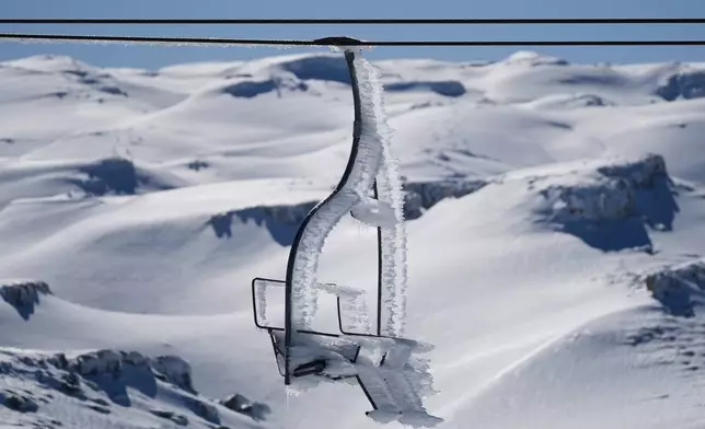 A chairlift is coated in ice from freezing winds at the Mzaar-Kfardebian ski resort northeast of Beirut, Lebanon, Saturday, Jan. 3, 2026. (AP Photo/Hassan Ammar)