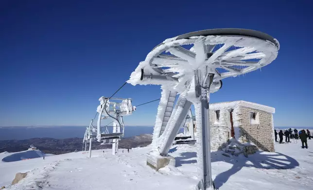 A ski lift covered in ice and snow is seen at the Mzaar-Kfardebian ski resort northeast of Beirut, Lebanon, Saturday, Jan. 3, 2026. (AP Photo/Hassan Ammar)