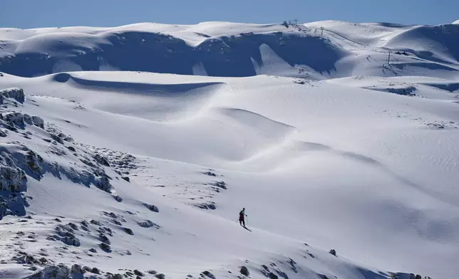 A lone skier crosses a snow-covered slope at the Mzaar-Kfardebian ski resort northeast of Beirut, Lebanon, Saturday, Jan. 3, 2026. (AP Photo/Hassan Ammar)