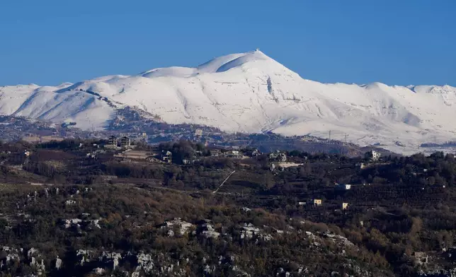 Mount Sannine is covered with snow as seen from the village of Faraya, northeast of Beirut, Lebanon, Saturday, Jan. 3, 2026. (AP Photo/Hassan Ammar)