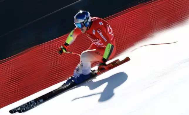 Switzerland's Marco Odermatt speeds down the course during a men's World Cup super-G, in Kitzbuehel, Friday, Jan. 23, 2026. (AP Photo/Gabriele Facciotti)