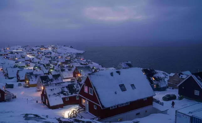 Houses covered by snow are seen on the coast of a sea inlet of Nuuk, Greenland, on Monday, Jan. 12, 2026. (AP Photo/Evgeniy Maloletka)