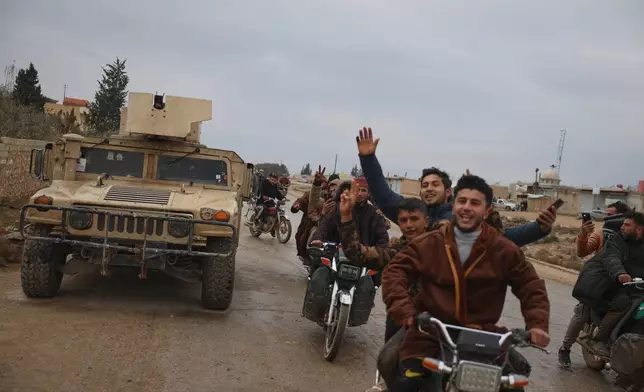 FILE - People celebrate as Syrian government forces enter the town of Deir Hafer, Saturday, Jan. 17, 2026, following the withdrawal of the U.S.-backed Syrian Democratic Forces. (AP Photo/Omar Albam, File)