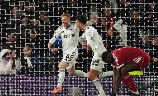 Fulham's Harrison Reed, left, celebrates after scoring his side's second goal during the English Premier League soccer match between Fulham and Liverpool in London, Sunday, Jan. 4, 2026. (AP Photo/Alastair Grant)