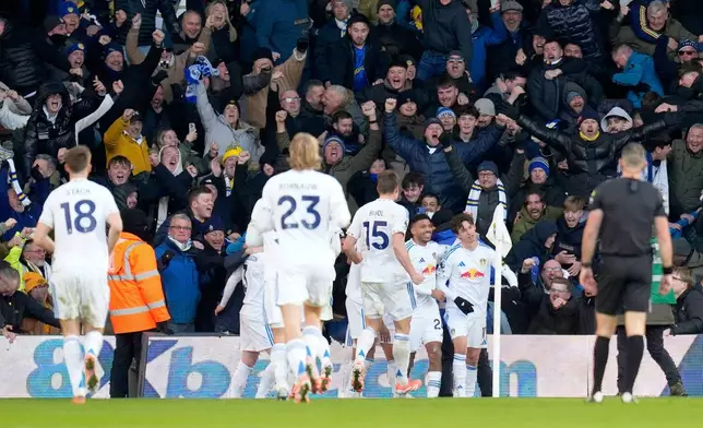Leeds United's Brenden Aaronson, right, celebrates with his teammates after scoring his sides first goal during the English Premier League soccer match between Leeds United and Manchester United in Leeds, England, Sunday, Jan. 4, 2026. (Danny Lawson/PA via AP)