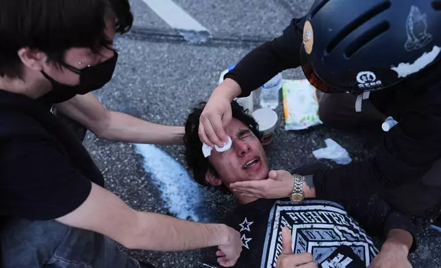 A protester's eyes are washed out after getting tear gassed during a scuffle between federal police at the Metropolitan Detention Center in downtown Los Angeles on Friday, Jan. 30, 2026. (AP Photo/Jae C. Hong)