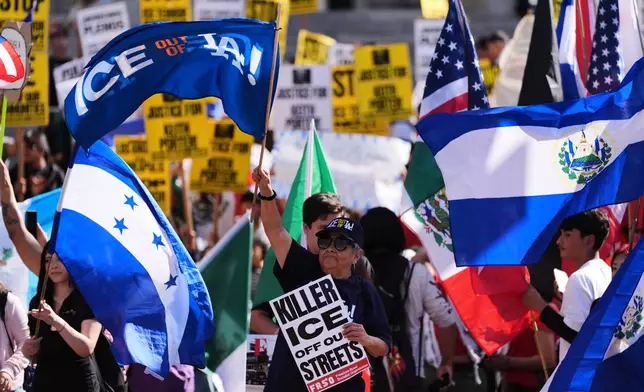 People gather during a protest on Friday, Jan. 30, 2026, in Los Angeles. (AP Photo/Jae C. Hong)