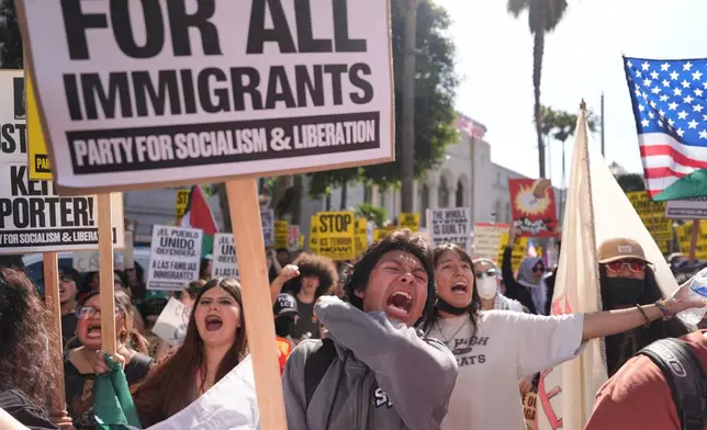 People gather near Los Angels City Hall, during a protest on Friday, Jan. 30, 2026. (AP Photo/Jae C. Hong)