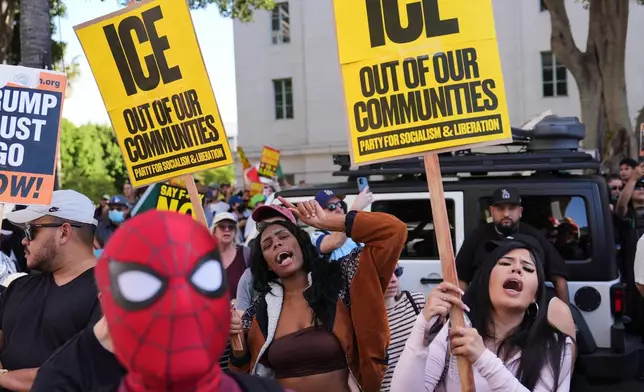 People gather during a protest on Friday, Jan. 30, 2026, in Los Angeles. (AP Photo/Jae C. Hong)