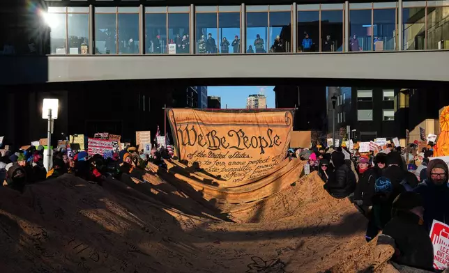 People gather during a protest Friday, Jan. 30, 2026, in Minneapolis. (AP Photo/Adam Gray)